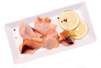 Smoked swordfish on the tray on white background seen from above