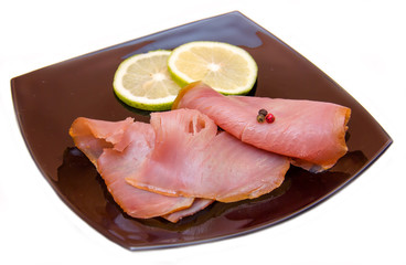 Smoked tuna on black plate on white background