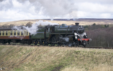 Fototapeta na wymiar Steam Train pulling Passenger Service in the Uk