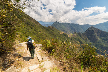 Fototapeta na wymiar Backpacker exploring Machu Picchu trails, Peru