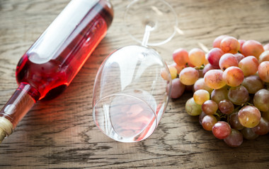 Glass of rose wine with bunch of grape