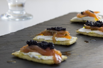canape with salmon, cheese and caviar