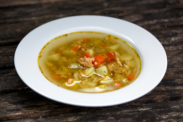 Fish soup with salmon, on wooden table
