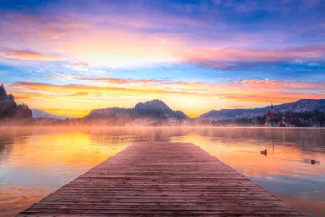 Fotobehang Amazing sunrise at the lake Bled in winter © Kavita