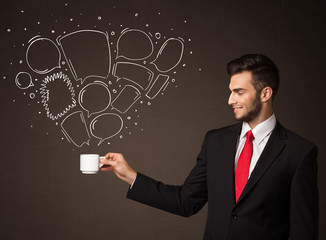 Businessman holding a white cup with speech bubbles
