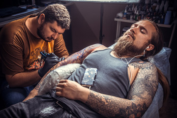 Master posing in tattoo studio