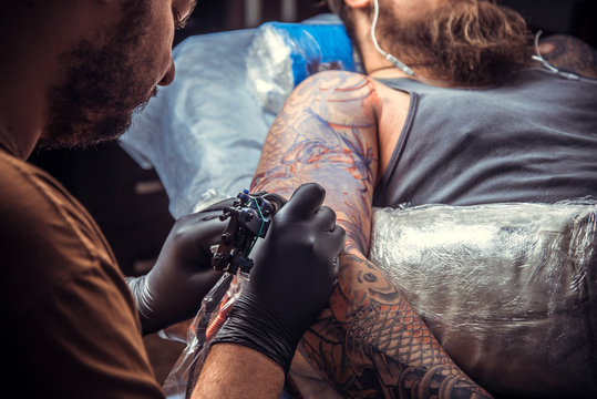 Professional tattoo artist create tattoo in studio