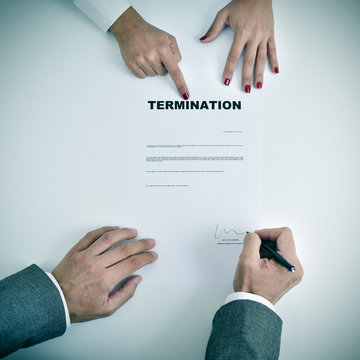 man signing a termination document