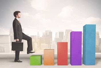 Plakat Business person climbing up on colourful chart pillars concept
