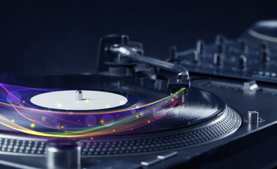 Fototapeta na wymiar Turntable playing vinyl with glowing abstract lines