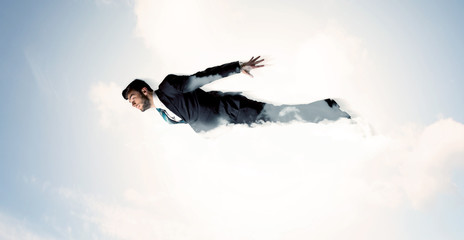 Business man flying like a superhero in clouds on the sky