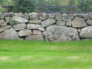 Traditional drystone wall fence as house boundary in Falkenberg, Sweden.