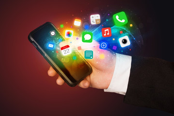 Hand holding smartphone with colorful app icons