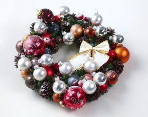 green christmas wreath with decorations isolated on white