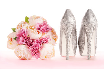A bouquet and brilliant silver shoes. Wedding bridal fashion image. 