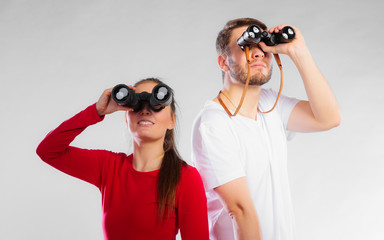 Couple looking through binoculars