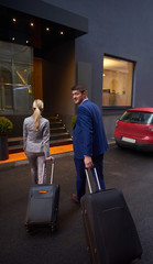 Fototapeta na wymiar business people couple entering hotel