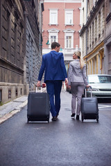 business people couple entering  hotel