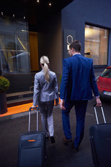 business people couple entering  hotel