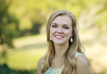 Outdoors portrait of beautiful young blonde girl 