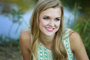 Outdoors portrait of beautiful young blonde girl 