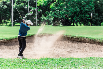 Yong asian golfer explosion sand.