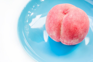 Ripe peach in ceramic plate
