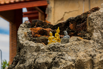 Small buddha statue on the broken pagoda.