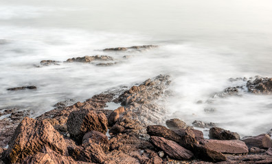 Foggy waters surrounding by rocks