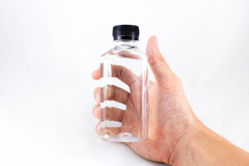 Hand holding full bottle of water