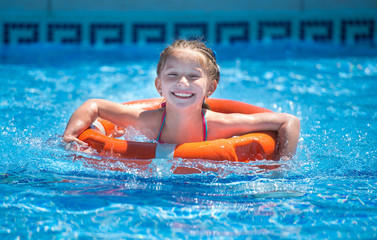 happy little girl in a wetsuit 