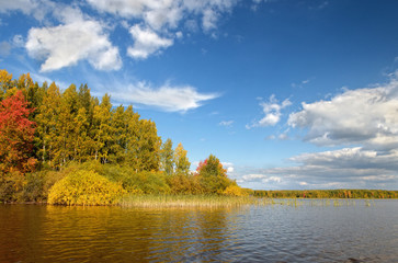 Landscape colorful autumn forest lake river sky clouds