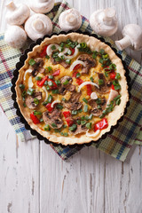 Tasty quiche with mushrooms in baking dish. vertical top view
