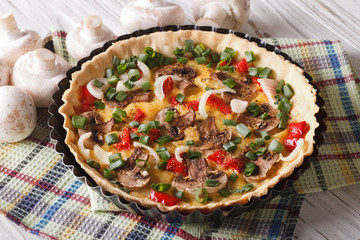 delicious quiche with mushrooms close up in baking dish. Horizontal
