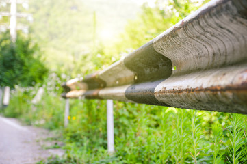 Rusted guardrail on the road. Selective focus