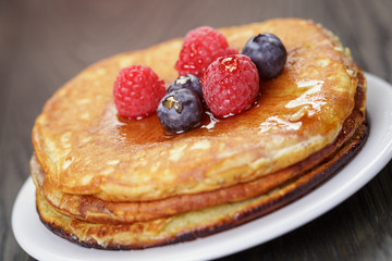 Pancakes with raspberry, blueberry and maple syrup