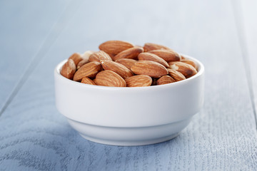 roasted almonds in white bowl