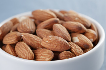 roasted almonds in white bowl