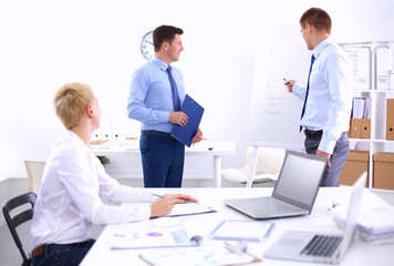 Business people sitting and discussing at business meeting, in