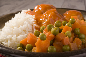 white rice, peas and carrots and delicious meatballs in tomato sauce 