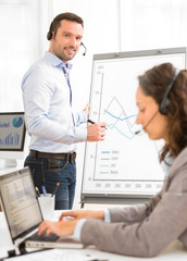Fototapeta premium Business man and woman analysing stats while doing video confere