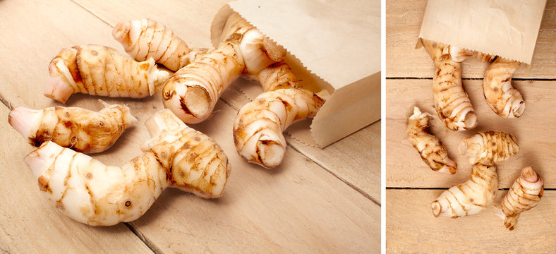 fresh galangal isolated on a wooden background