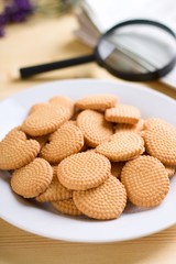 Plate with crispy biscuits next to window