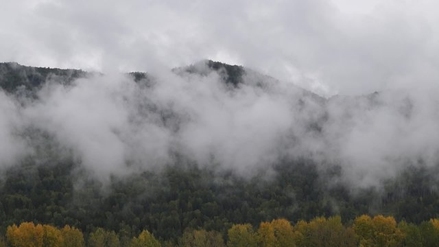 Timelapse of the Manzherok fumes from the lake in Altai in overcast autumn morning.