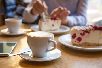 Fototapeta na wymiar coffee and cheesecake with raspberries