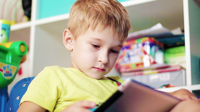 little boy playing on the tablet
