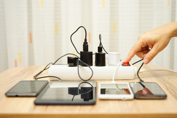 man is turning off  power adapters for mobile phones and tablet