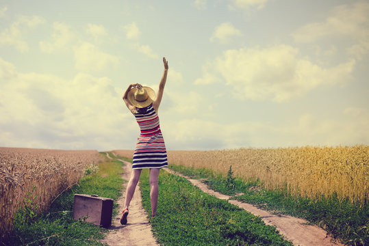Young lady in starw hat enjoying nature and travelling with