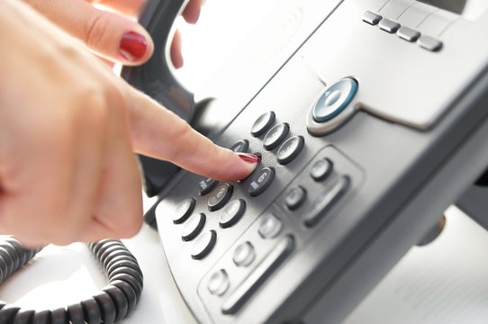 Female finger dialing telephone  number