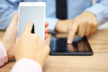 Businesswoman and businessman using smart mobile phone and digit